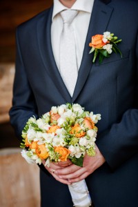 groom with flowers